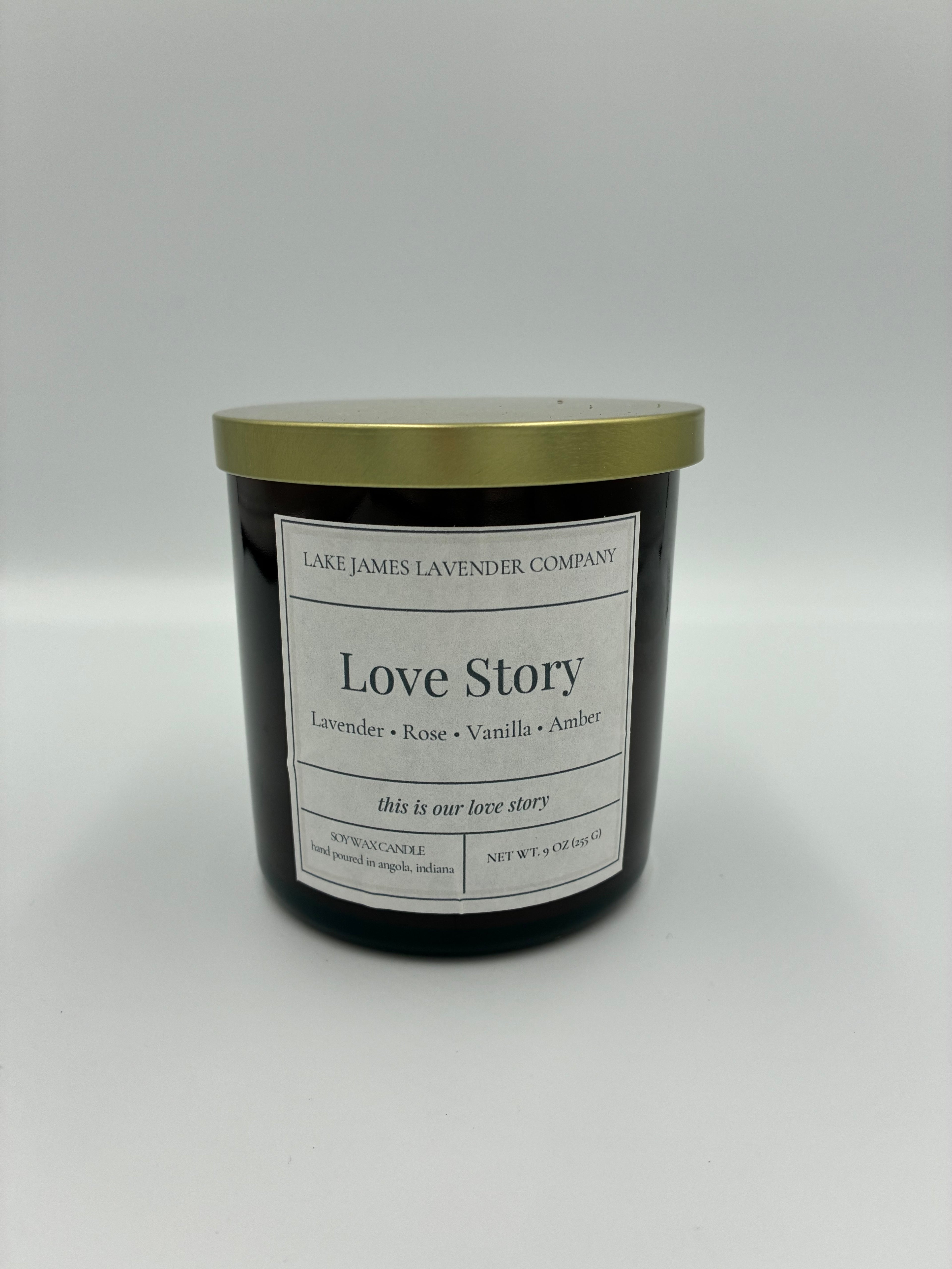 Candle jar labeled 'Love Story' on a white background