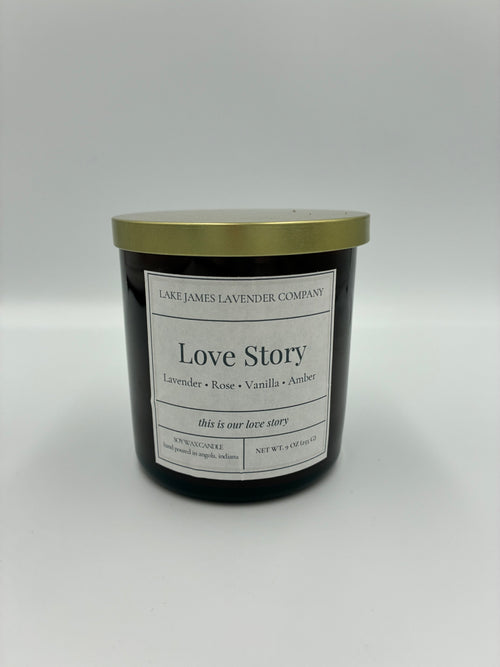 Candle jar labeled 'Love Story' on a white background