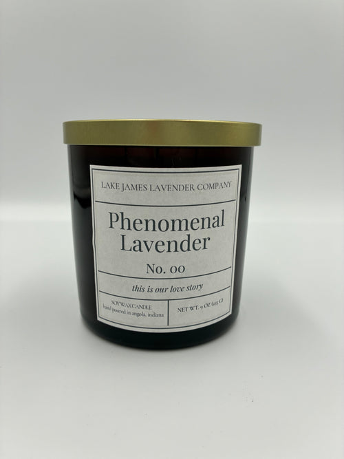 Black candle with gold lid and white label on a white background