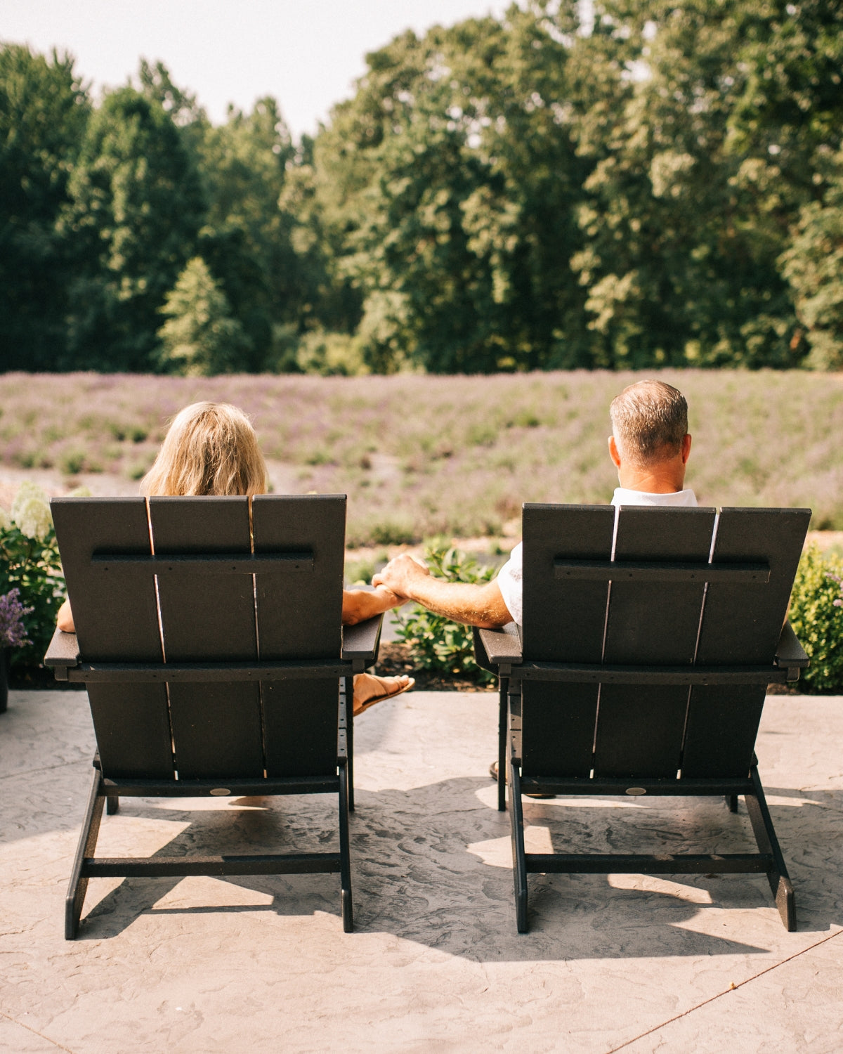 Founders seated overlooking the lavender fields at Lake James Lavender Company in Angola, Indiana