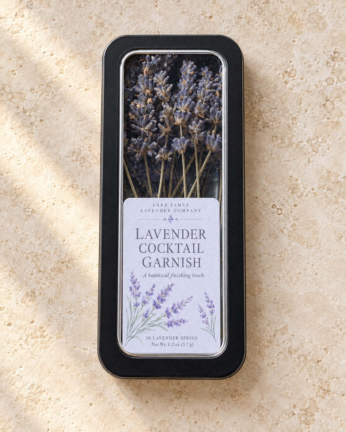 Lavender Cocktail Garnish window tin containing 30 culinary lavender sprigs, with Lake James Lavender Company label.